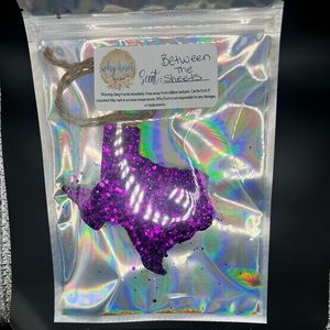 3” round, between the sheets, purple Texas shaped car candle.